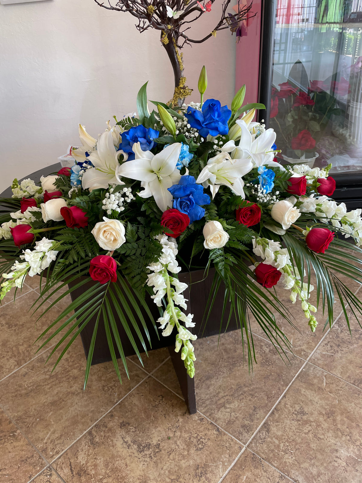 Casket Spray Blue and Red by Bianca's Flowers